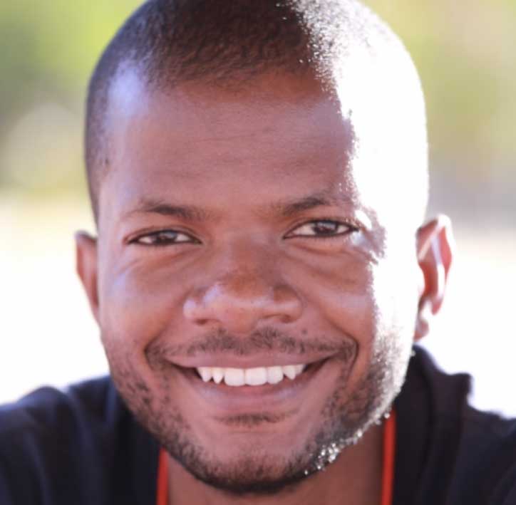 Cropped headshot of James Chirombo with blurred background
