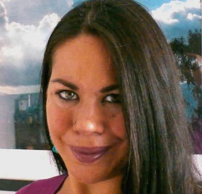 Cropped headshot of Tanya Chung Tiam Fook in front of an art piece