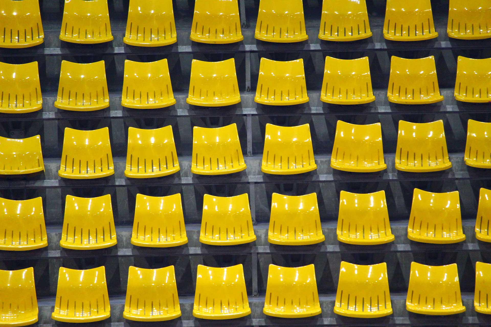 Banner image of yellow chairs aligned in multiple rows and columns