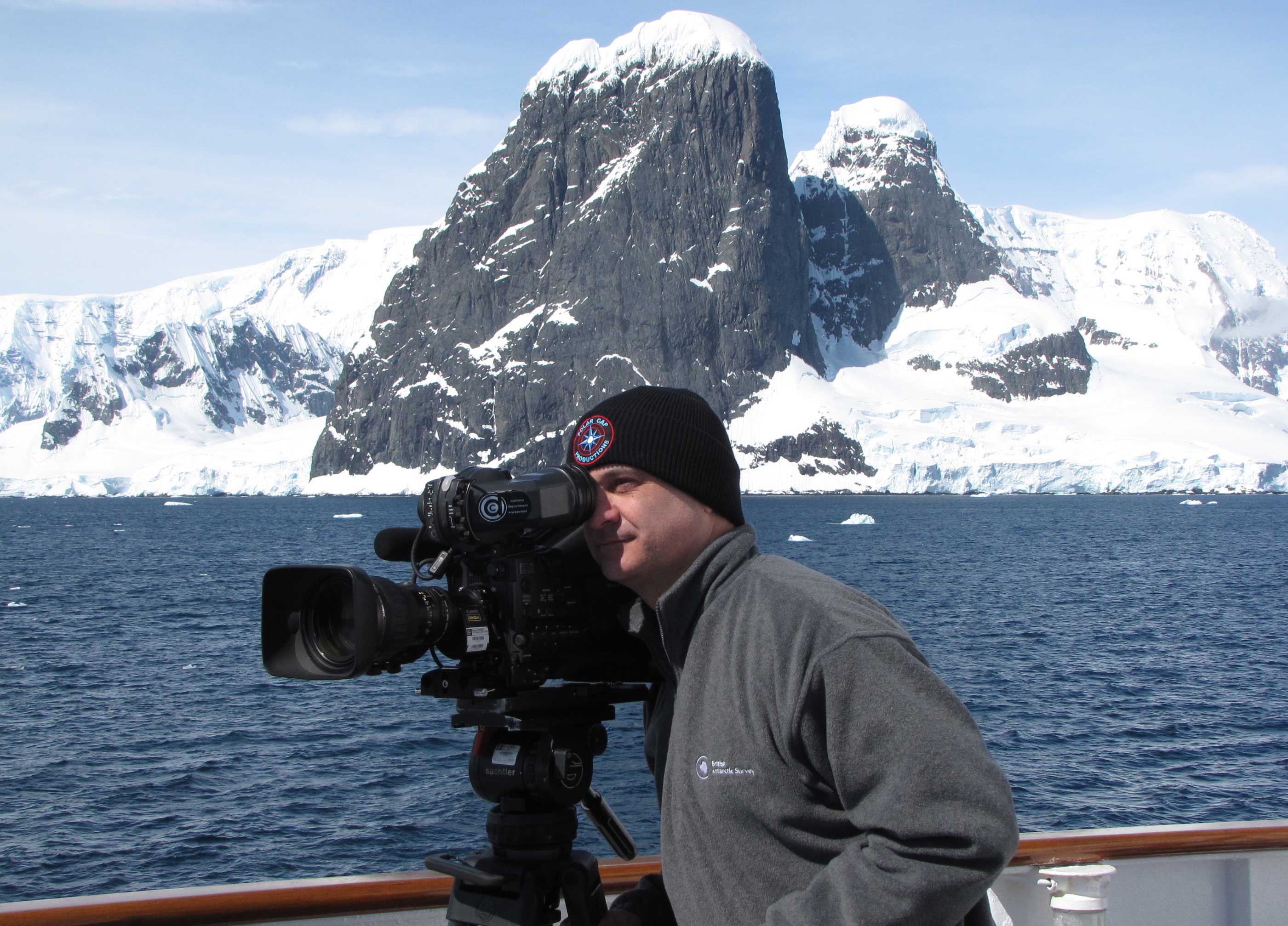 portrait shot of Mark Terry filming in the polar ocean